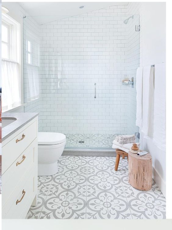 Banheiro com ladrilho branco e cinza e paredes com subway tiles